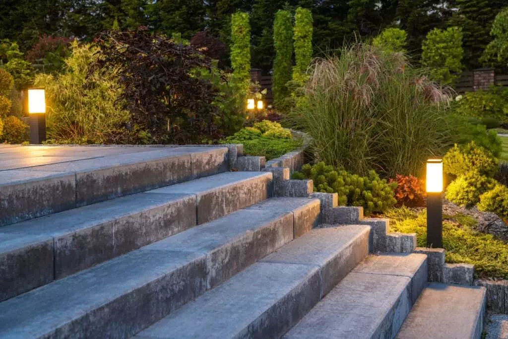 landscaped garden with concrete stairs and decorative illuminati